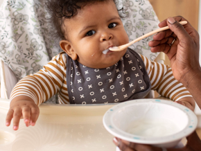 Baby in highchair eating 